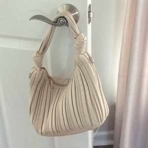 Buttery soft Urban Expression cream handbag.
